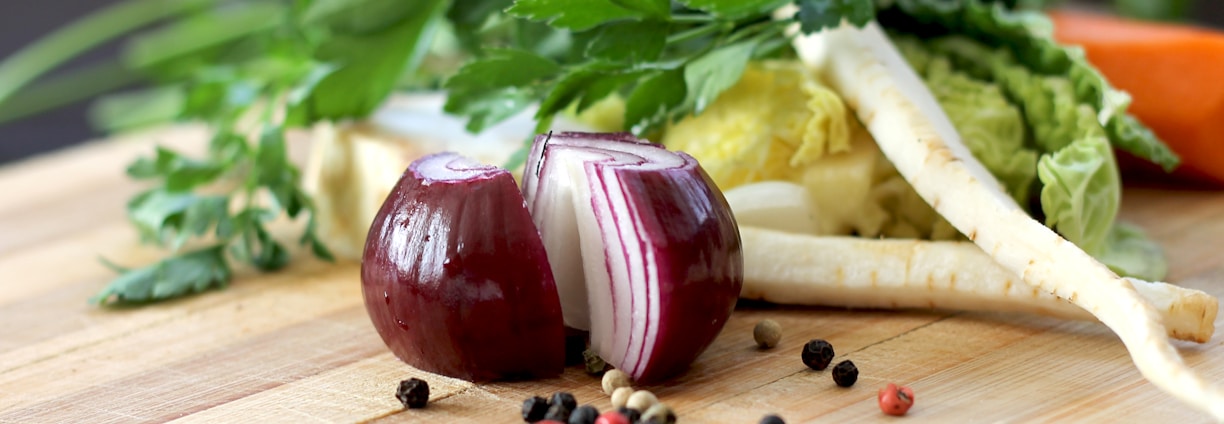 red onion on brown wooden chopping board