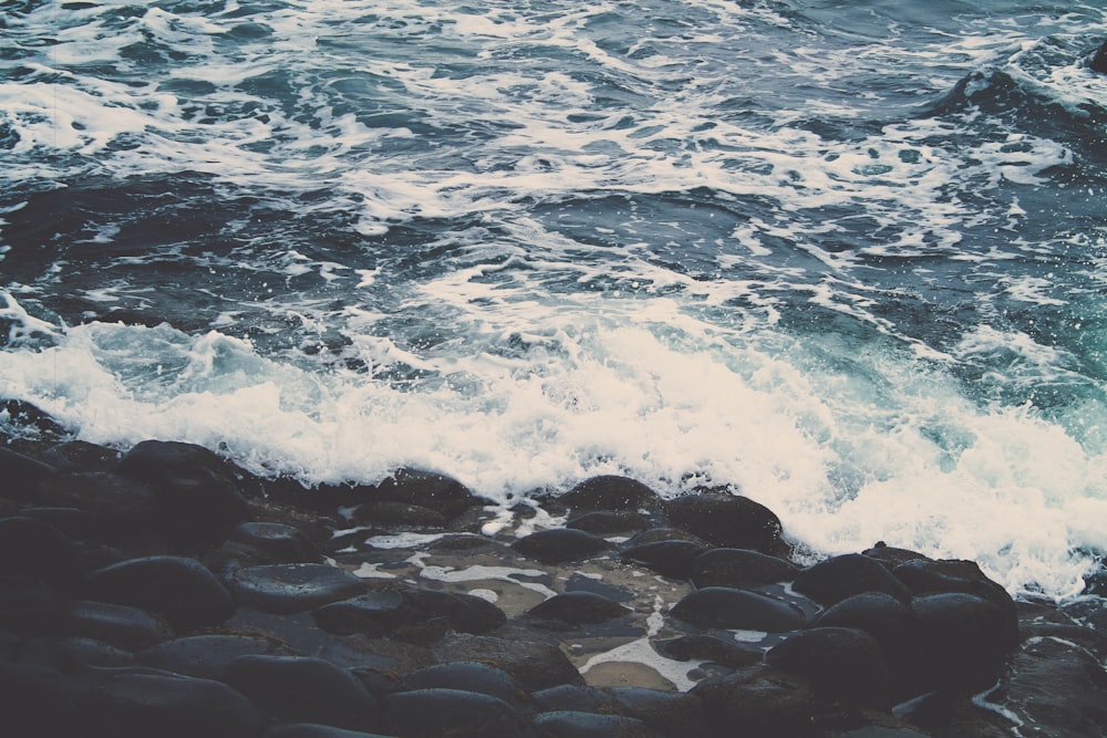 sea waves splashing through stone