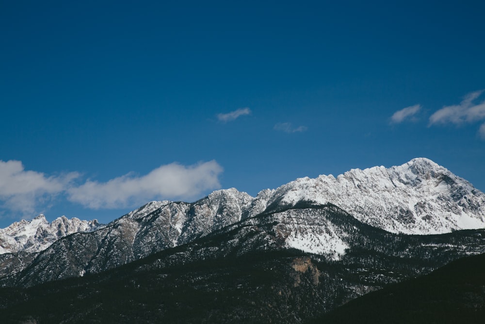 mountain ranges under white clouds during daytime