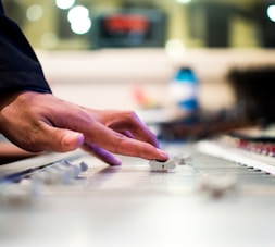 person holding mixing console