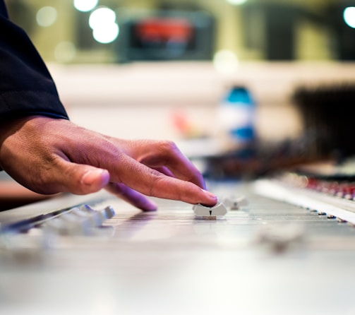 person holding mixing console