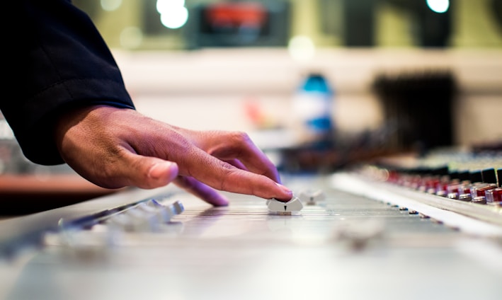 person holding mixing console