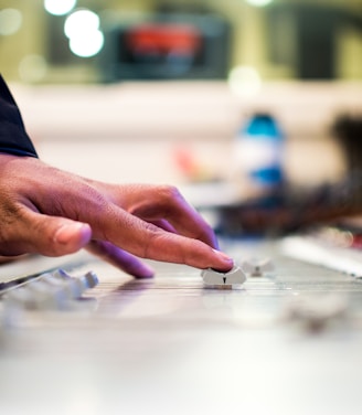 person holding mixing console