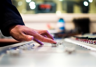 person holding mixing console