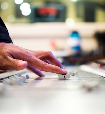 person holding mixing console