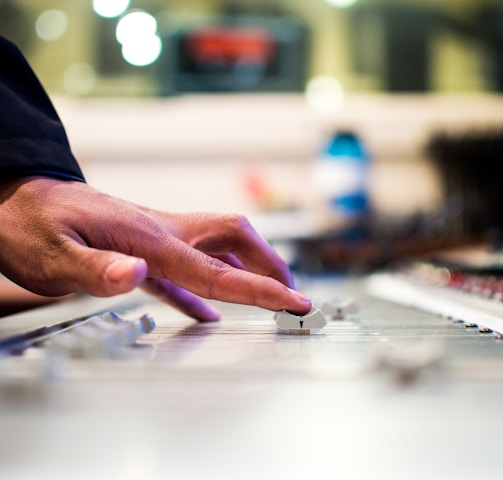 person holding mixing console