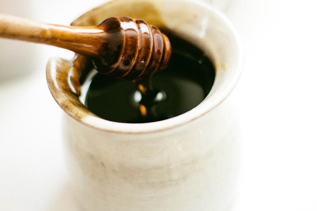 brown wooden honey dipper, Sweet honey in a jar
