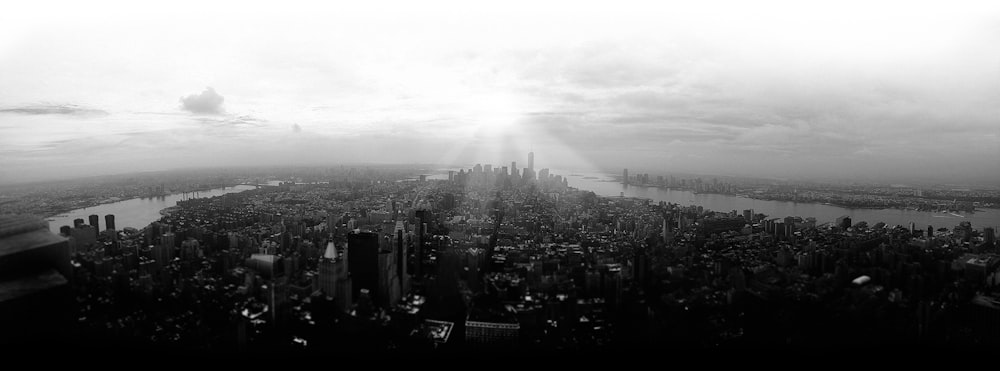 aerial photography of city beside body of water