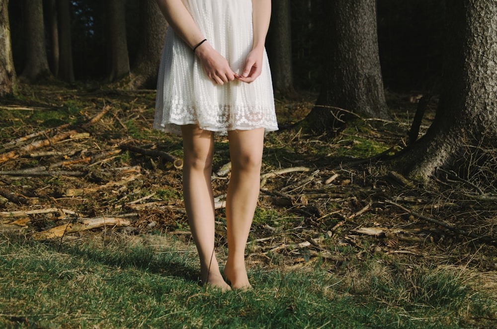 person standing beside trees