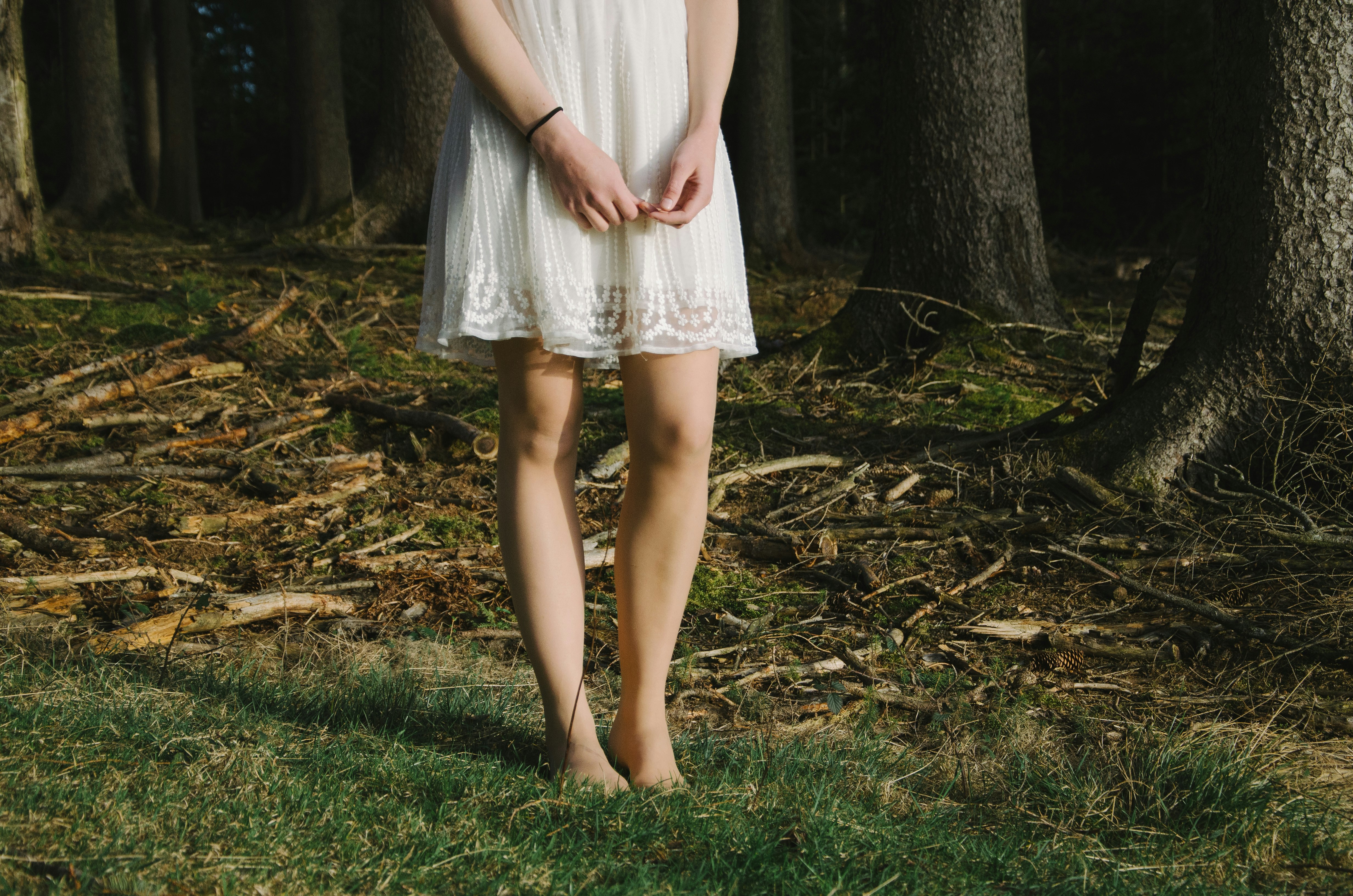 person standing beside trees