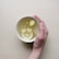 person holding white bowl with sliced lime and ginger inside