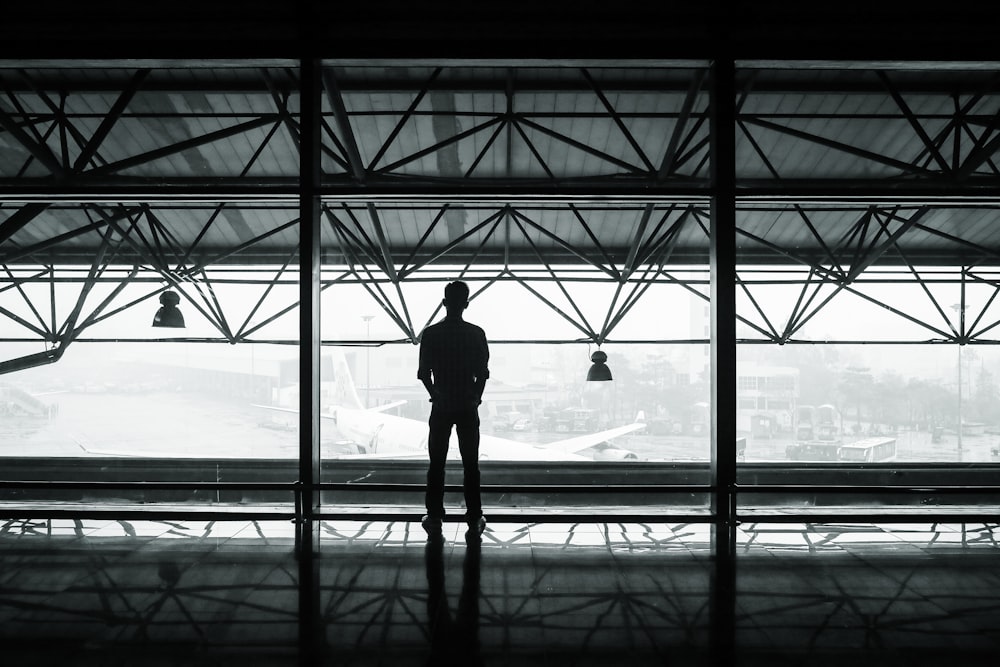 silhouette of man standing between two posts