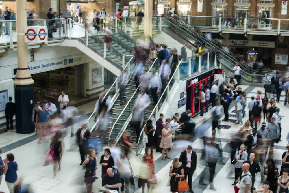 people standing and walking on stairs in mall