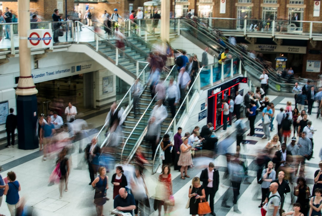 people standing and walking on stairs in mall people standing and walking on stairs in mall