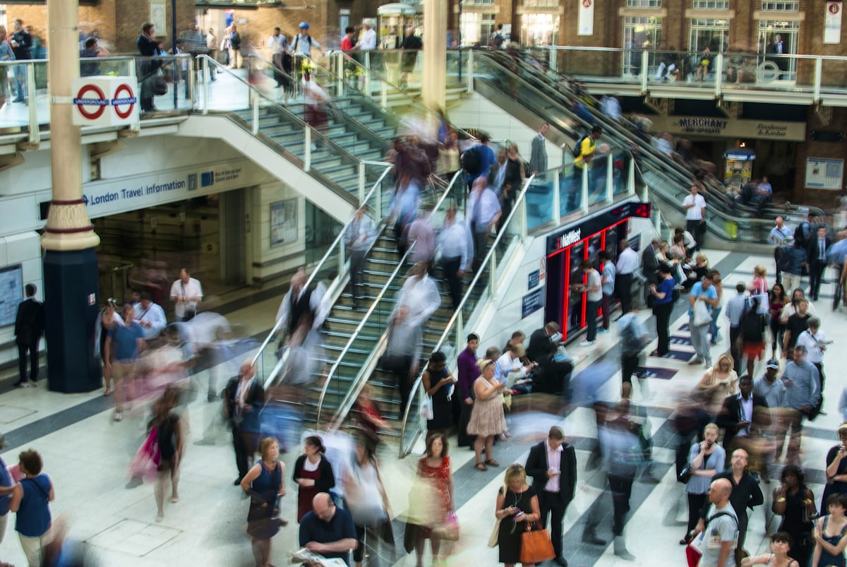 people standing and walking on stairs in mall
