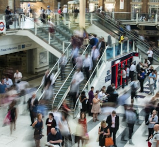 people standing and walking on stairs in mall