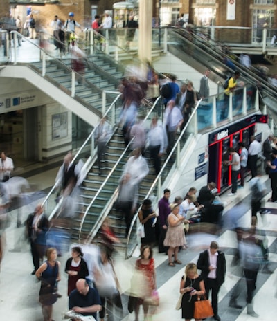 people standing and walking on stairs in mall