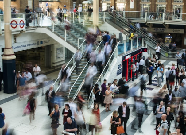 people standing and walking on stairs in mall