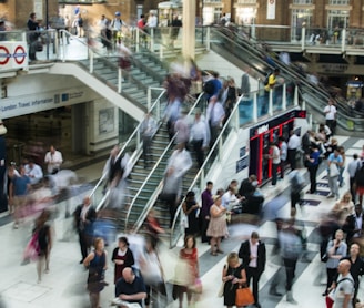 people standing and walking on stairs in mall