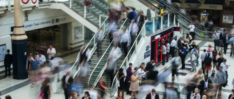 people standing and walking on stairs in mall