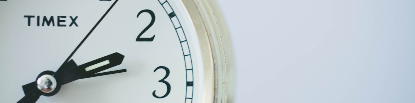 round Timex analog clock at 2:33