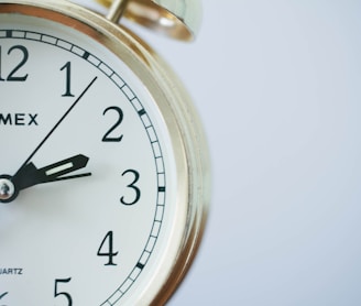 round Timex analog clock at 2:33