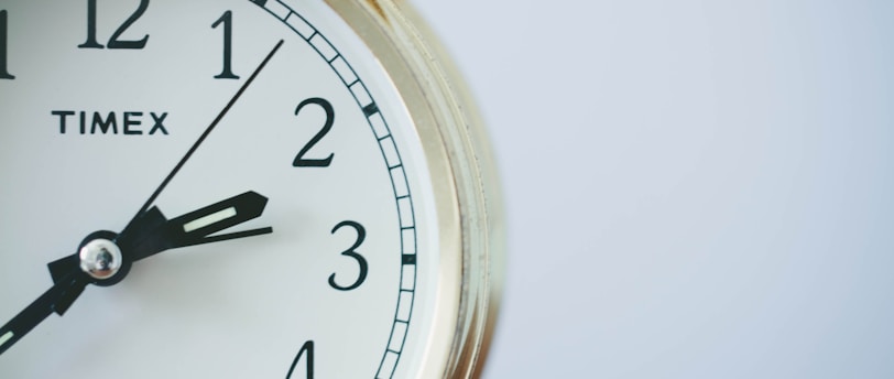 round Timex analog clock at 2:33