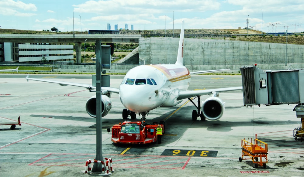 white airplane on airport during day time