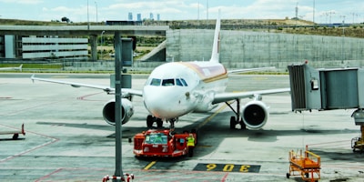 white airplane on airport during day time