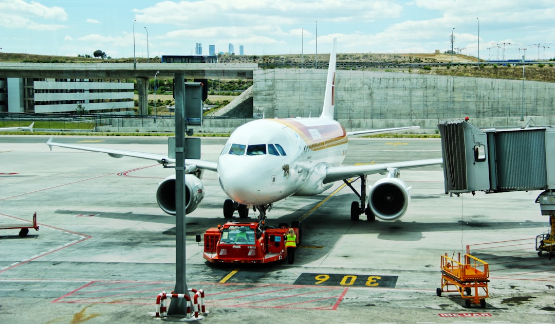 white airplane on airport during day time, Plane dragged on the tarmac