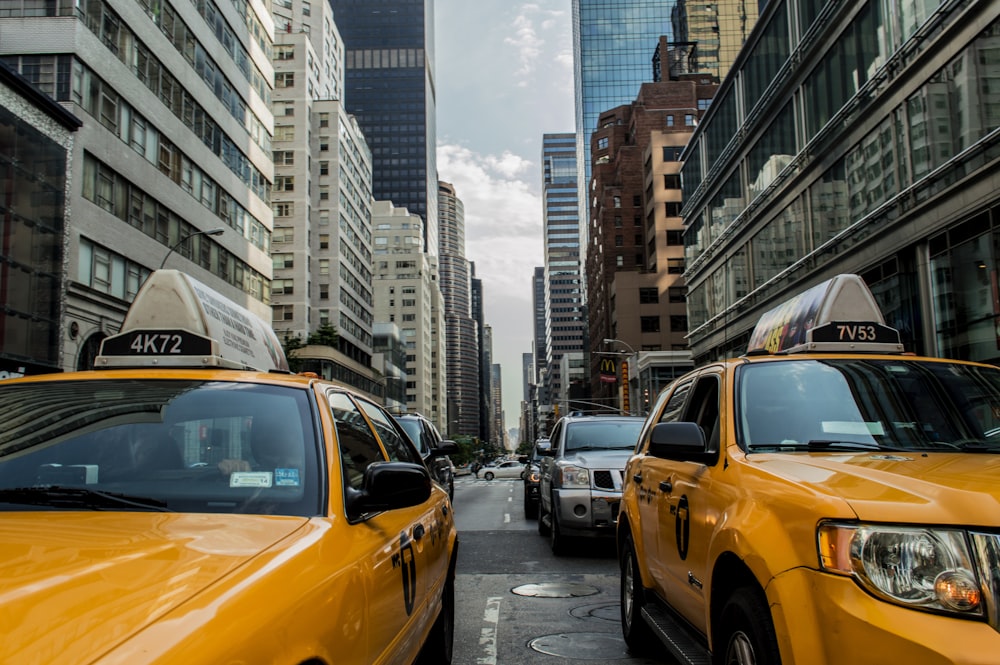 two yellow cars between buildings