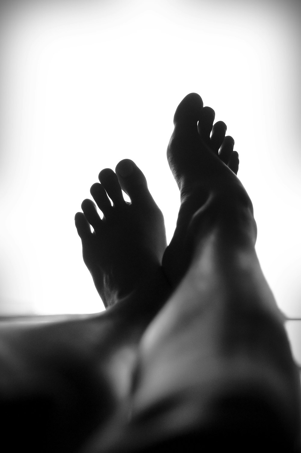 silhouette of person's feet against white background
