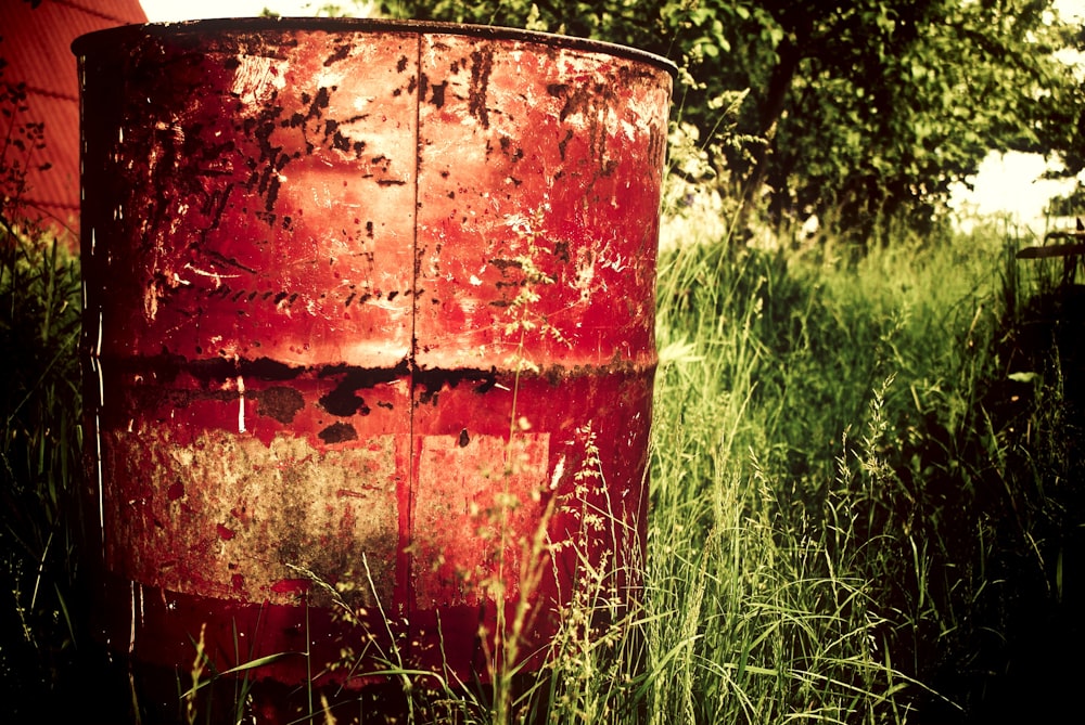 brown metal barrel on grass field