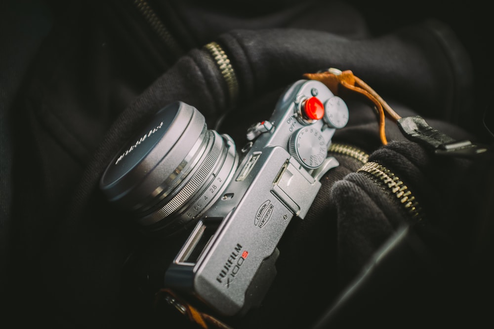 closeup photo of mirrorless camera on zip-up top