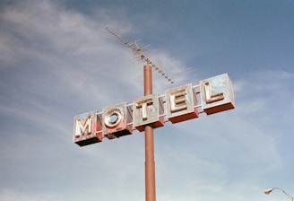 brown metal Motel road sign at daytime