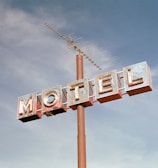 brown metal Motel road sign at daytime