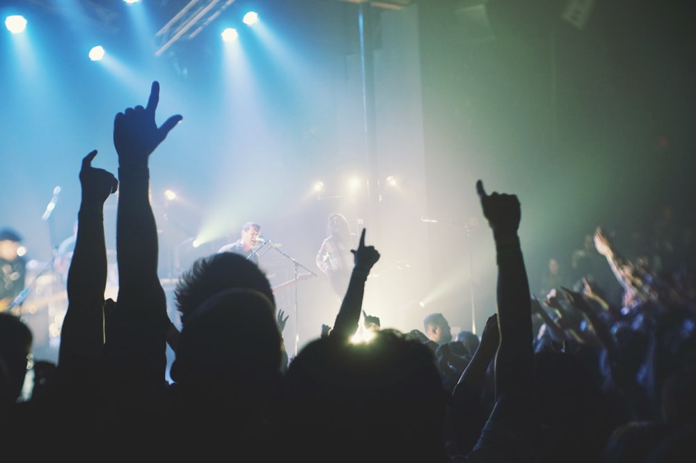 crowd cheering band during night time