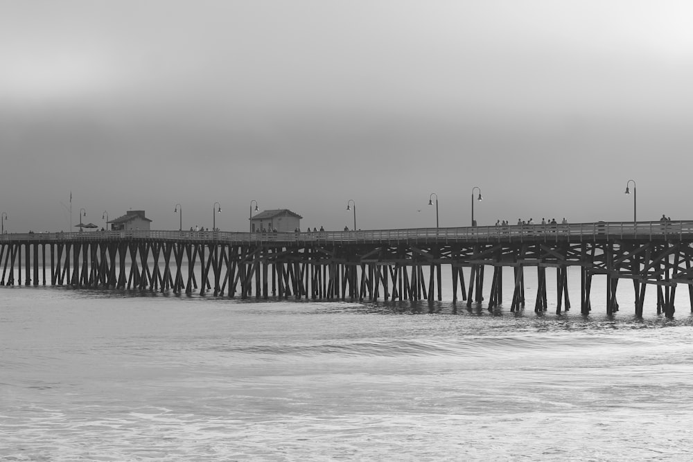 bridge over body of water on grayscale phot