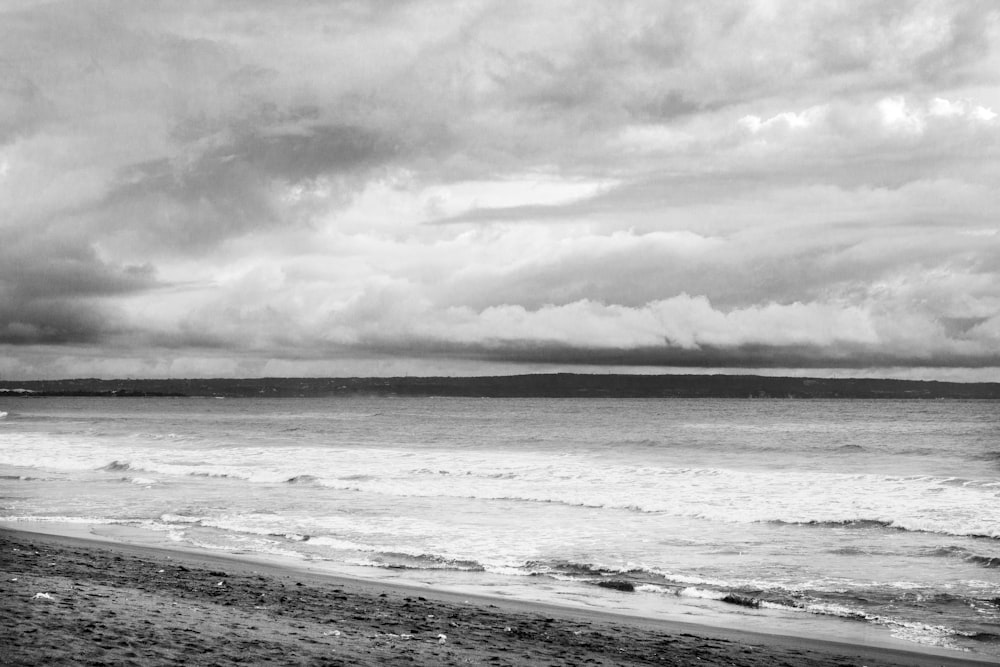grayscale photo of beach and sea
