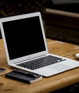 MacBook Air near mug on table