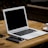 MacBook Air near mug on table