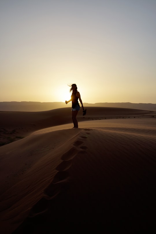 woman in black tank top and black shorts standing on brown sand during daytime in Aqaba Jordan