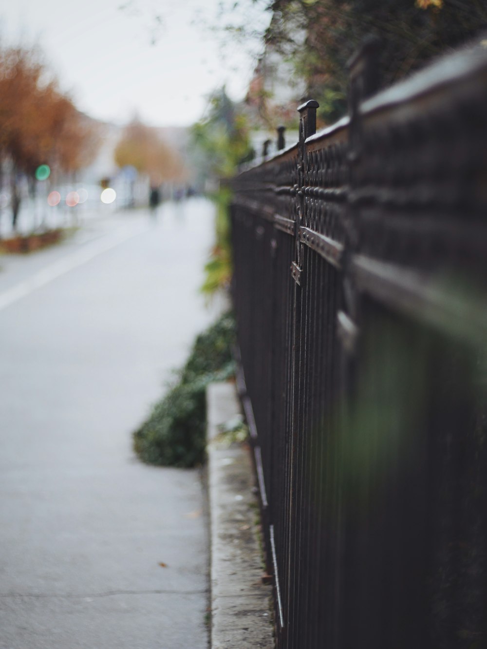 black metal fence near road during daytime