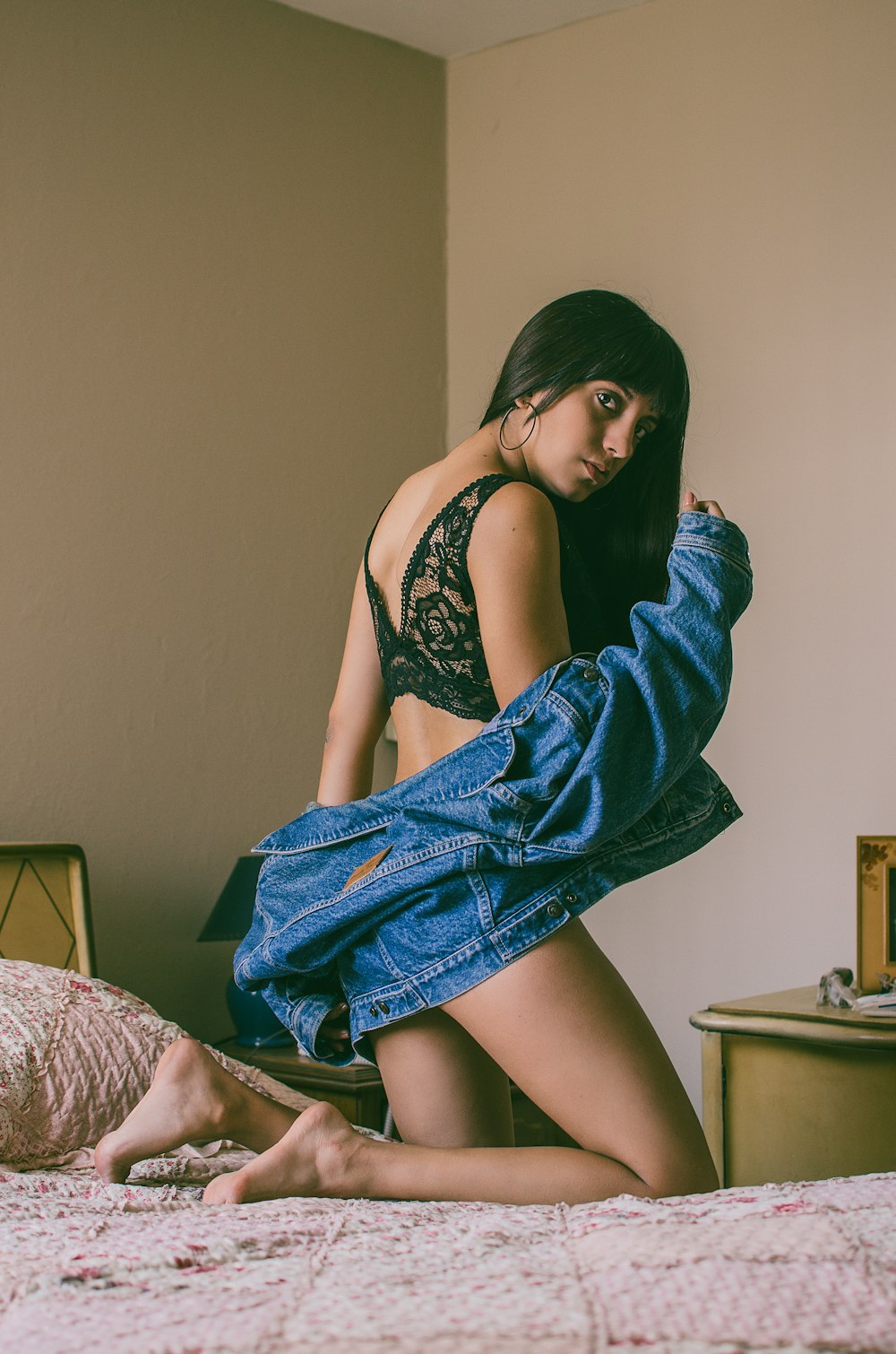 woman on bed wearing black lace brassiere