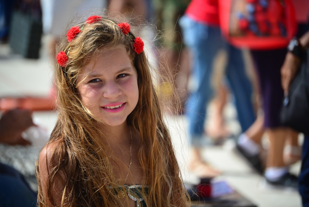 smiling girl with red flower headdress