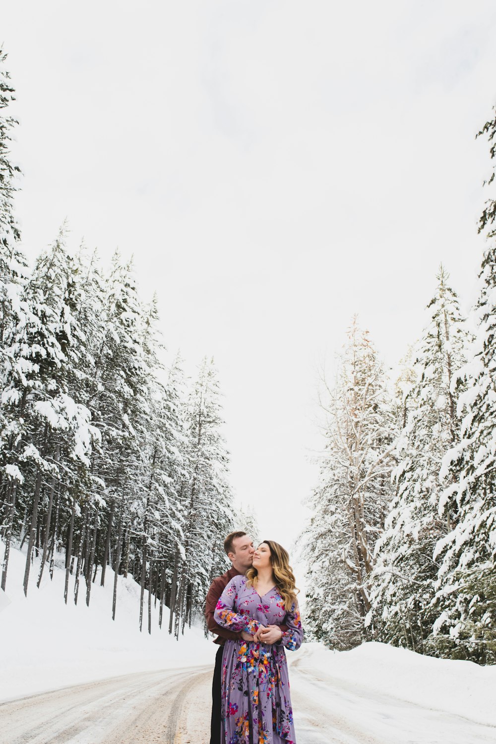 couple standing on snowy field