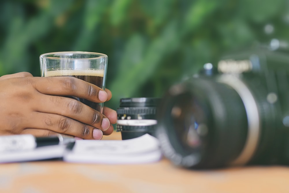 camera on table beside glass