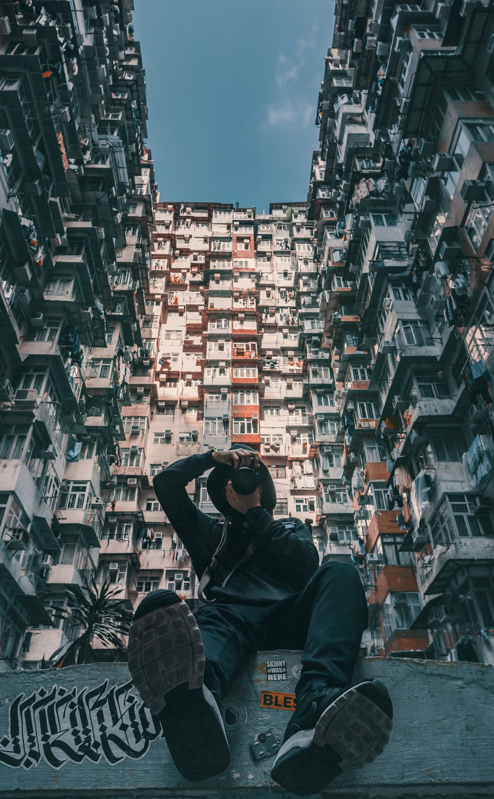 man taking photo of building