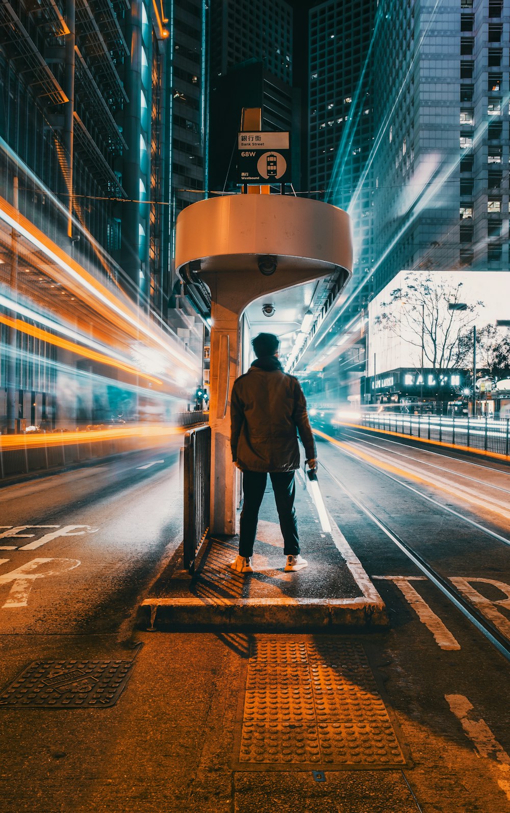 a man standing at a bus stop in the city