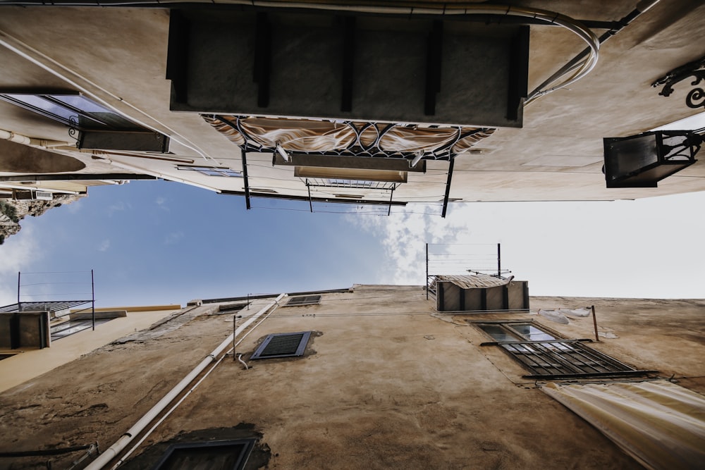 low angle photography of two brown concrete buildings